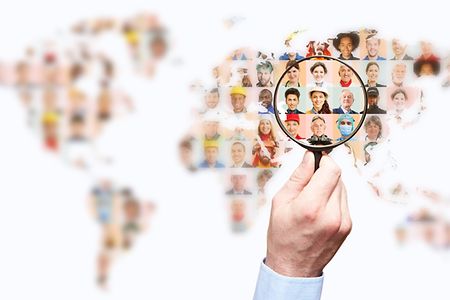 Hand,With,Magnifying,Glass,Searching,For,Suitable,Staff,On,World