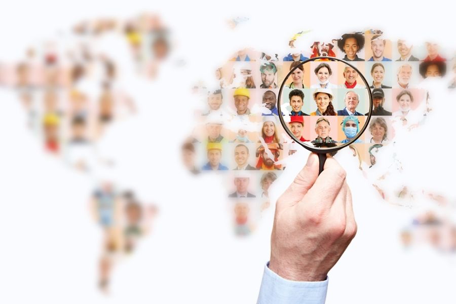 Hand,With,Magnifying,Glass,Searching,For,Suitable,Staff,On,World